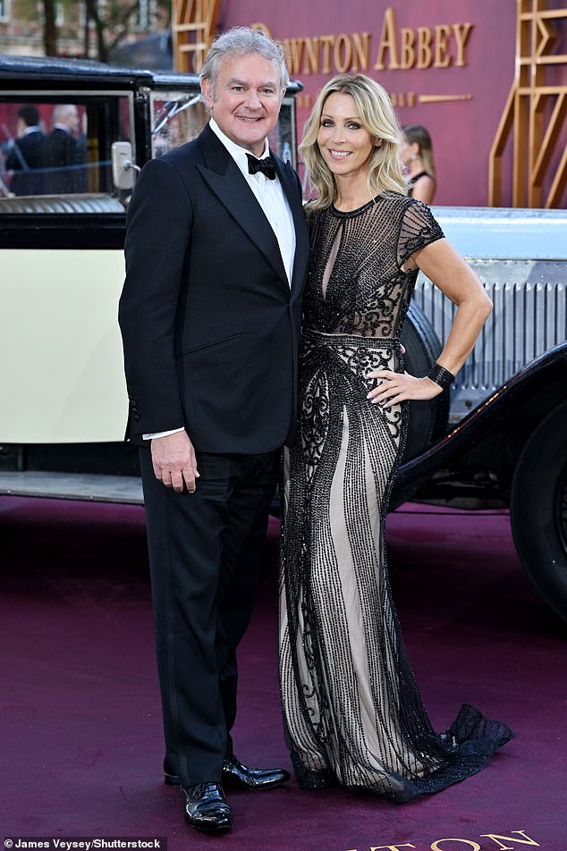 Mr Bonneville poses on a purple carpet in Leicester Square alongside his partner, Heidi Kadlecova
