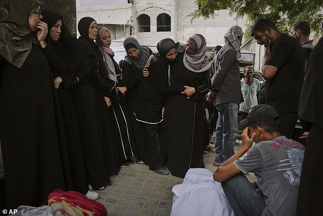 Palestinians mourn over the bodies of people who were killed in an Israeli army strike in Gaza City