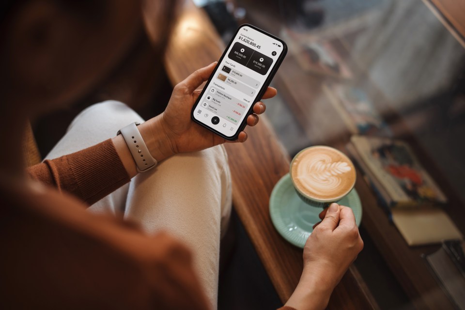 Woman checking her online banking app on her smartphone.