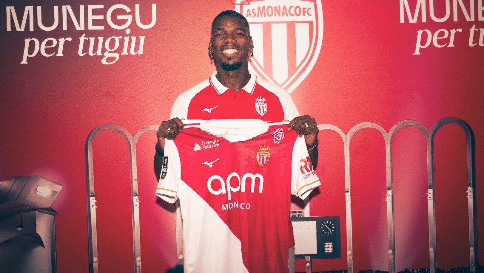 Paul Pogba holding a AS Monaco FC jersey.