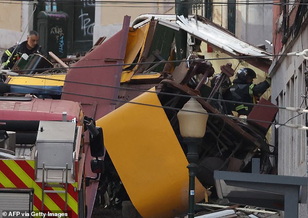 Police and firefighters work on the site of a funicular railway accident in Lisbon, September 3