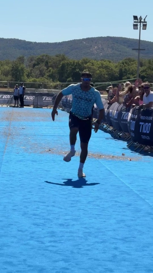 Tommy Fury finishing a triathlon.