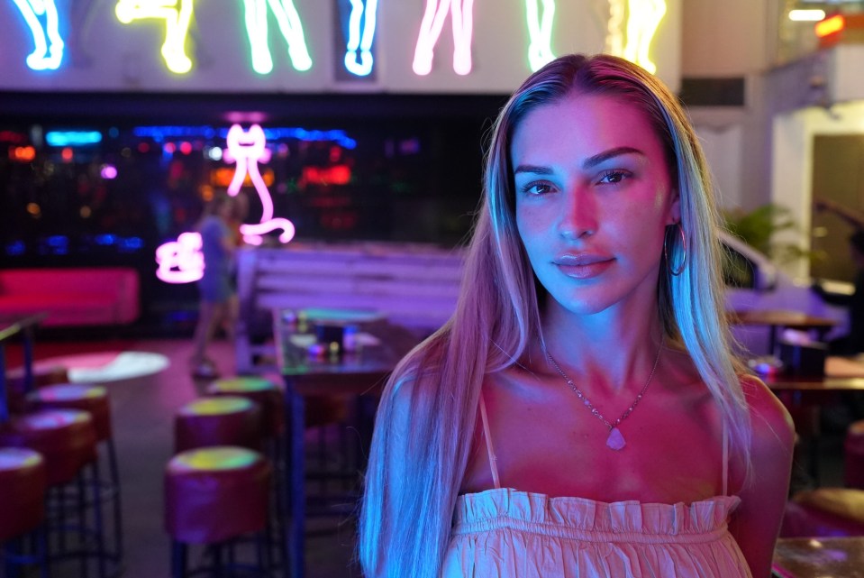 Woman at a neon-lit bar in Phuket.