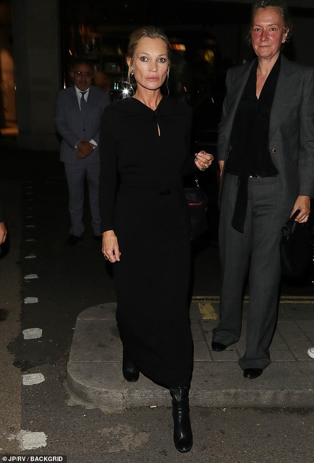 Kate completed her look with a pair of black leather heeled boots as she styled her hair with a swept-back updo