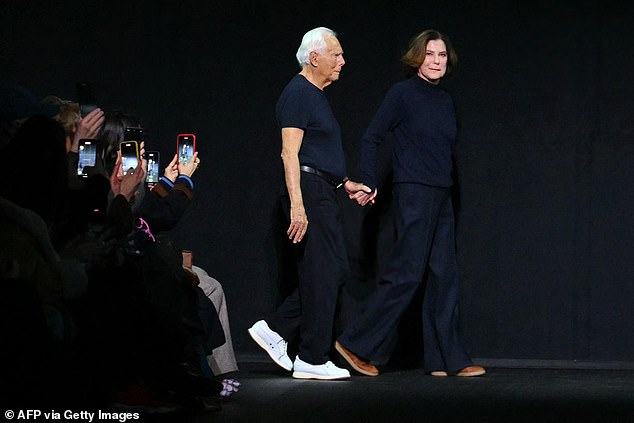 Giorgio Armani arrives on stage with his niece Silvana Armani at the end of the Emporio Armani Womenswear Ready-to-wear Fall-Winter 2025/2026 collection show during the Milan Fashion Week, in Milan on February 27, 2025