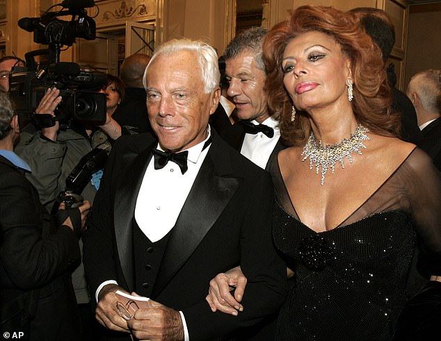 Italian actress Sophia Loren, right, and fashion designer Giorgio Armani arrive for the reopening of La Scala theater in Milan, Dec. 7, 2004