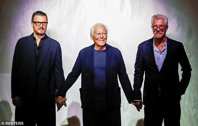 Giorgio Armani acknowledges applauses with Leo Dell'Orco and Gianluca Dell'Orco at the end of his Spring/Summer 2025 collection during Fashion Week in Milan, Italy, June 17, 2024