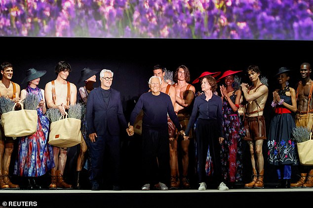 Giorgio Armani acknowledges applauses with Leo Dell'Orco and Silvana Armani at the end of his Emporio Armani spring/summer 2025 collection during the Fashion Week in Milan, Italy, June 15, 2024