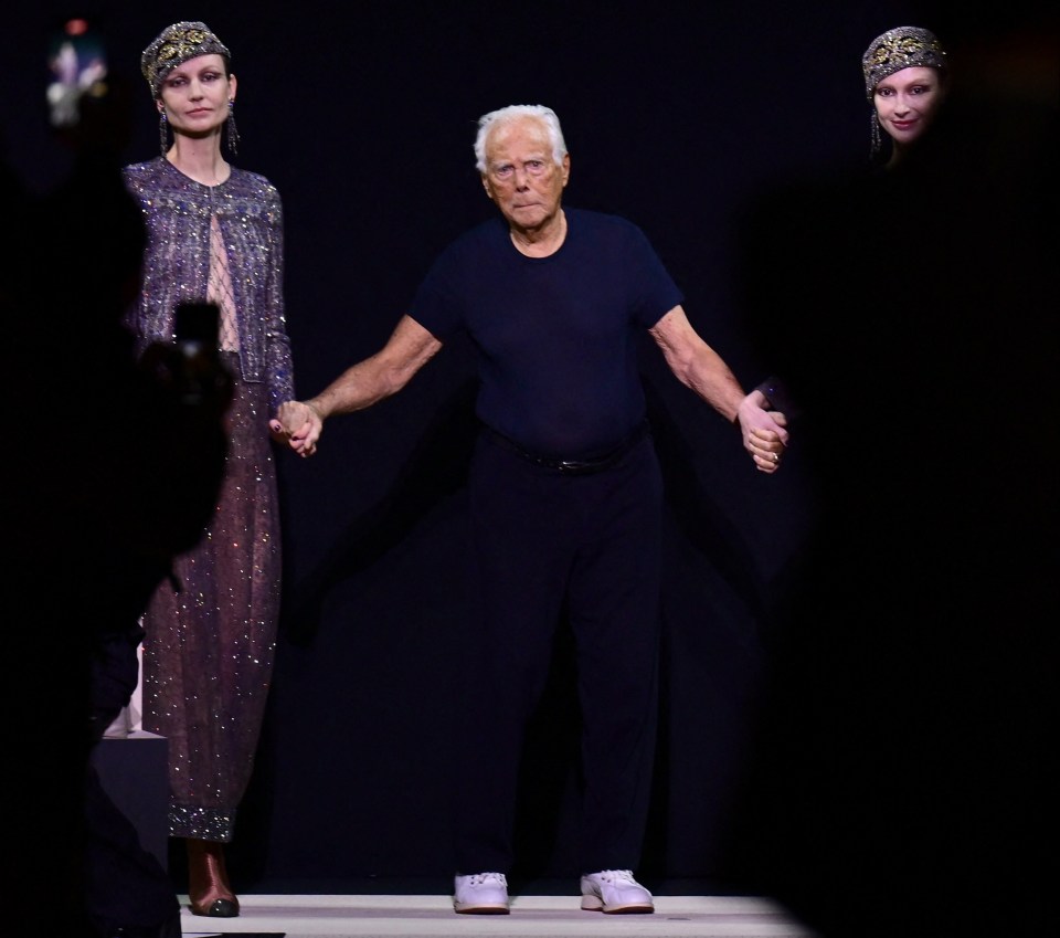Giorgio Armani with models at a fashion show.