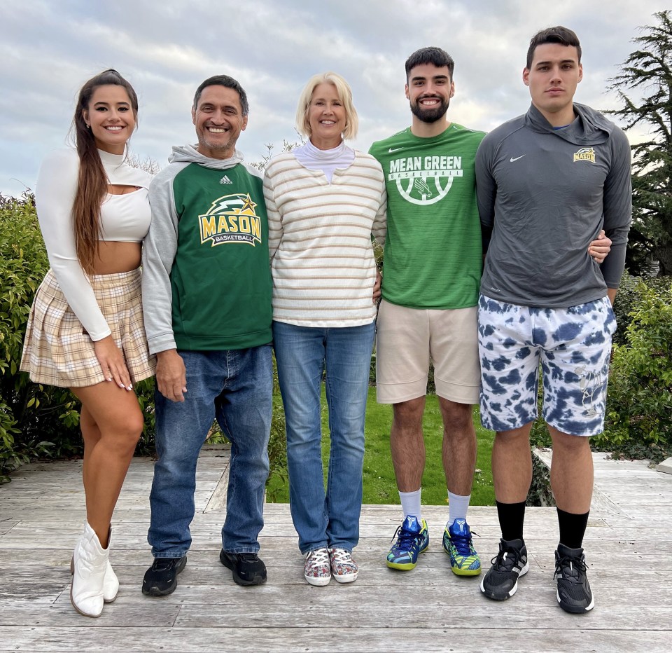 Photo of a family of five posing outdoors.