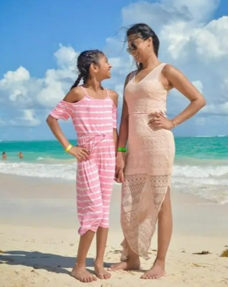 A mother and daughter on a beach.