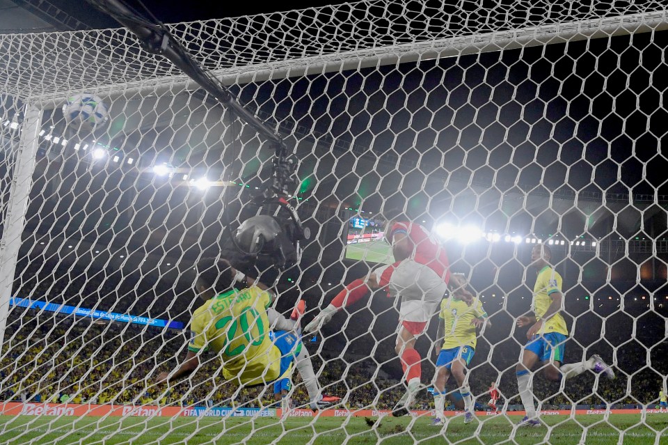 Soccer player #20 Estevao scoring a goal for Brazil.