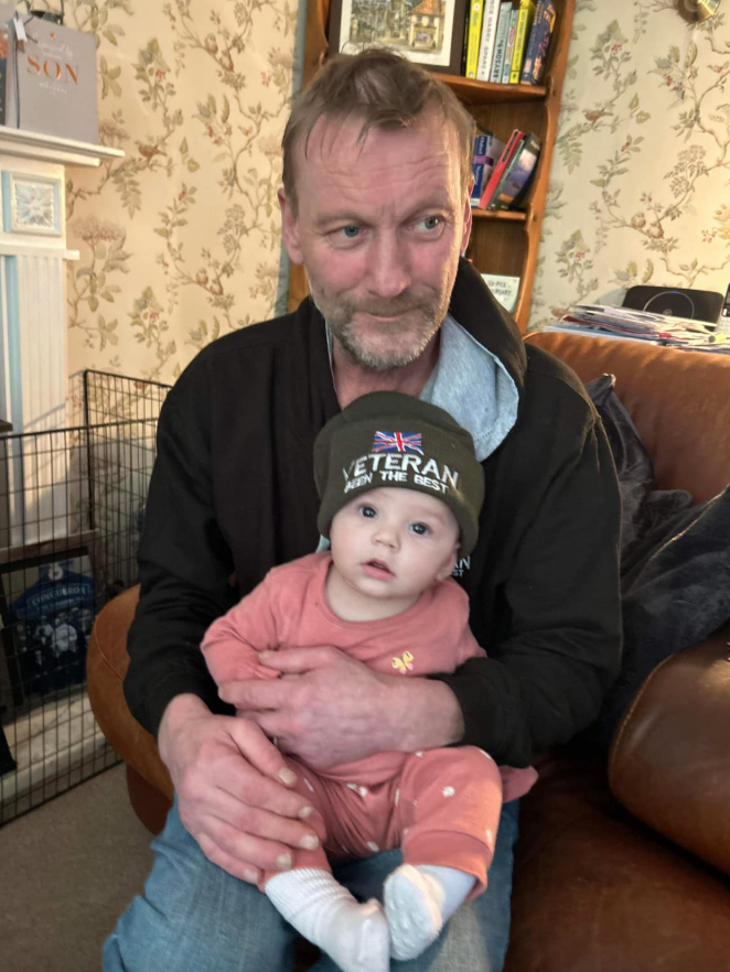 Photo of Peter Pile holding his eight-month-old granddaughter, Tilly-May Pile.