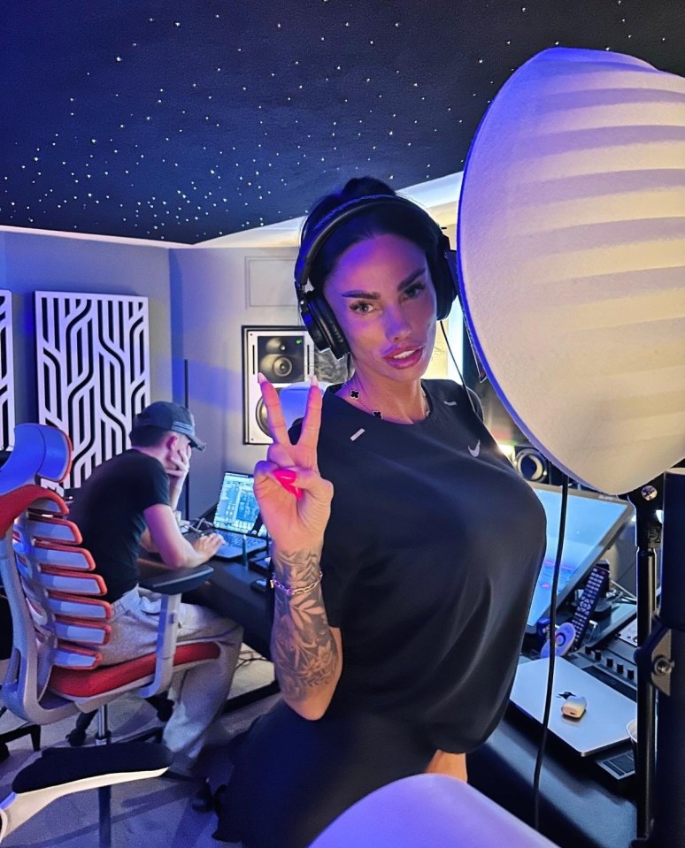 Katie Price in a recording studio giving a peace sign.