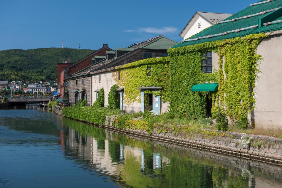 Otaru Canal in Hokkaido, Japan, with ivy-covered warehouses.