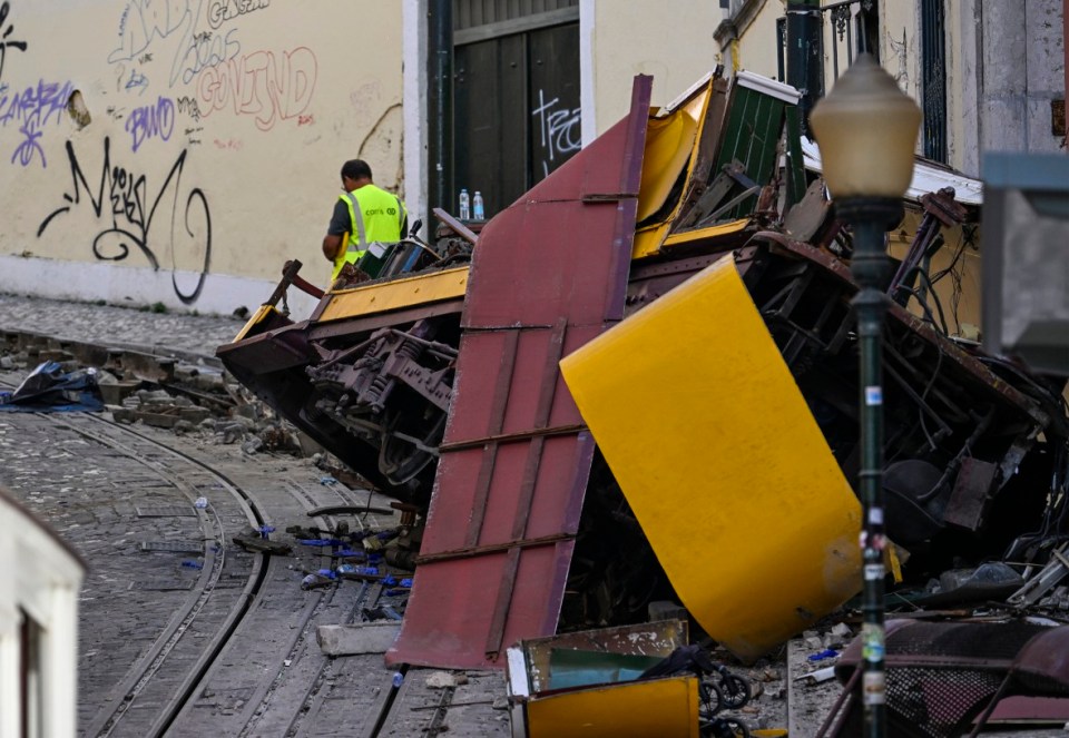 LISBON, PORTUGAL - SEPTEMBER 04: Carris personnel inspect the area surrounding the wrecked Gloria funicular on September 04, 2025 in Lisbon, Portugal. Seventeen people were killed and around 20 injured when a car on the Glória Funicular derailed in Lisbon. The iconic funicular railway line, also called Elevador da Glória, connects Lisbon's Restauradores Square to the neighborhood of Bairro Alto via a steep 275 meter (900ft) climb, and is popular among tourists. (Photo by Horacio Villalobos/Getty Images) *** BESTPIX ***