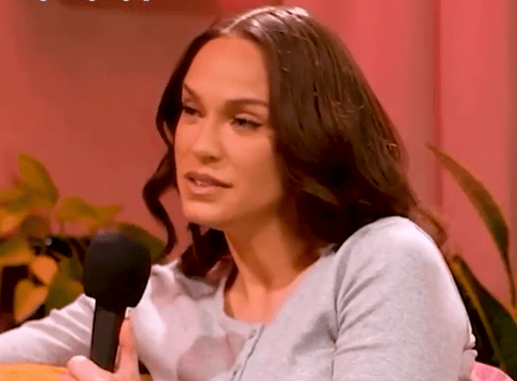 Vicky speaking into a microphone.