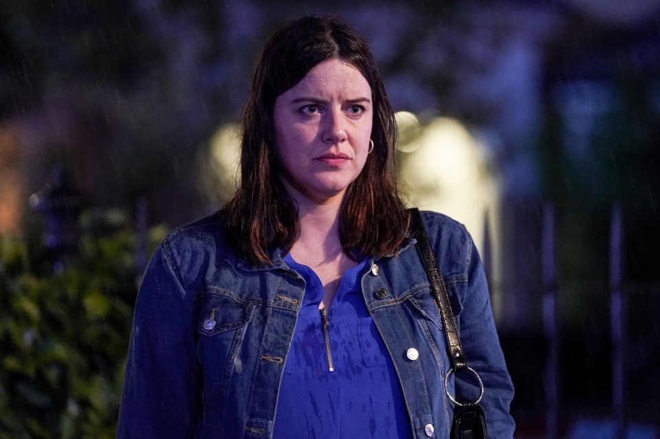 Woman in denim jacket looks concerned.