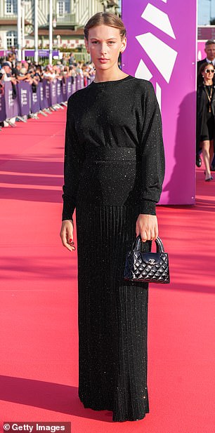 Lou Lampros cut a classy figure in a black textured gown
