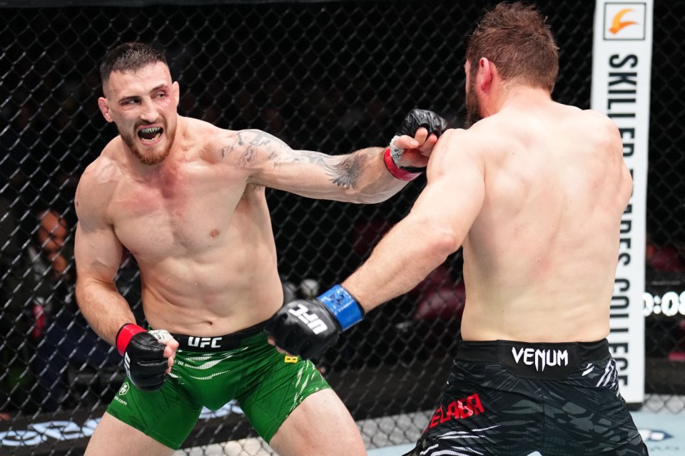Modestas Bukauskas punches Ion Cutelaba in a UFC light heavyweight bout.