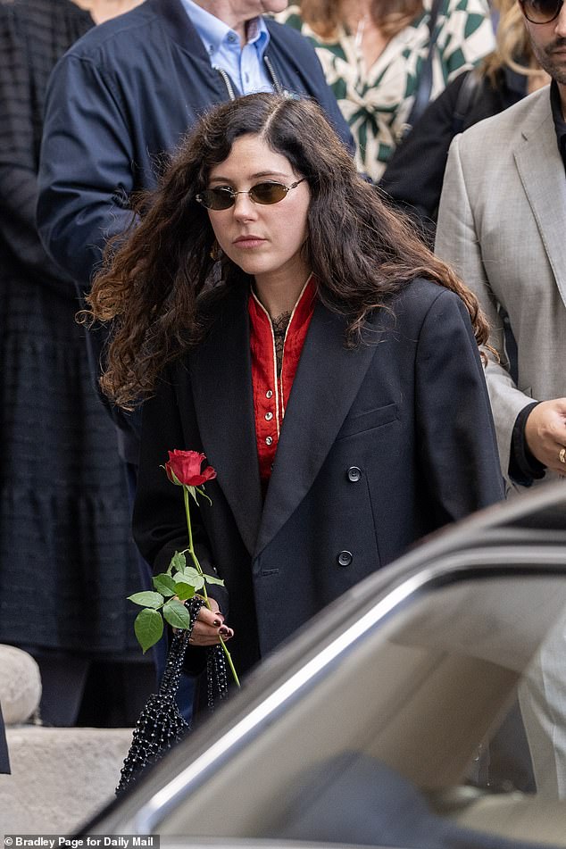 Eliza held a red rose as she paid respects to her dearly-missed grandmother