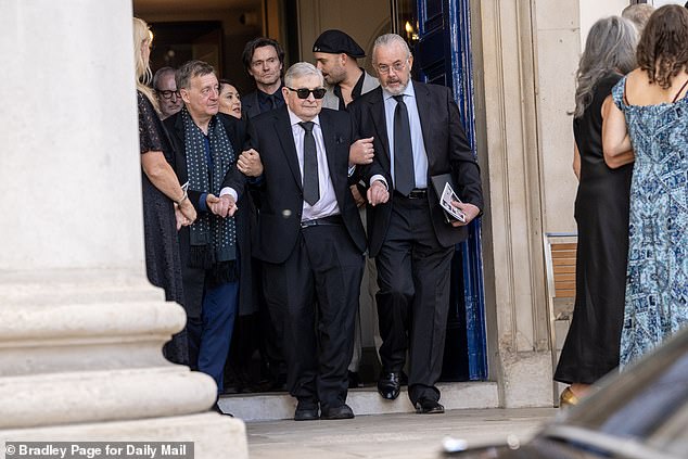 Family members gathered outside the service