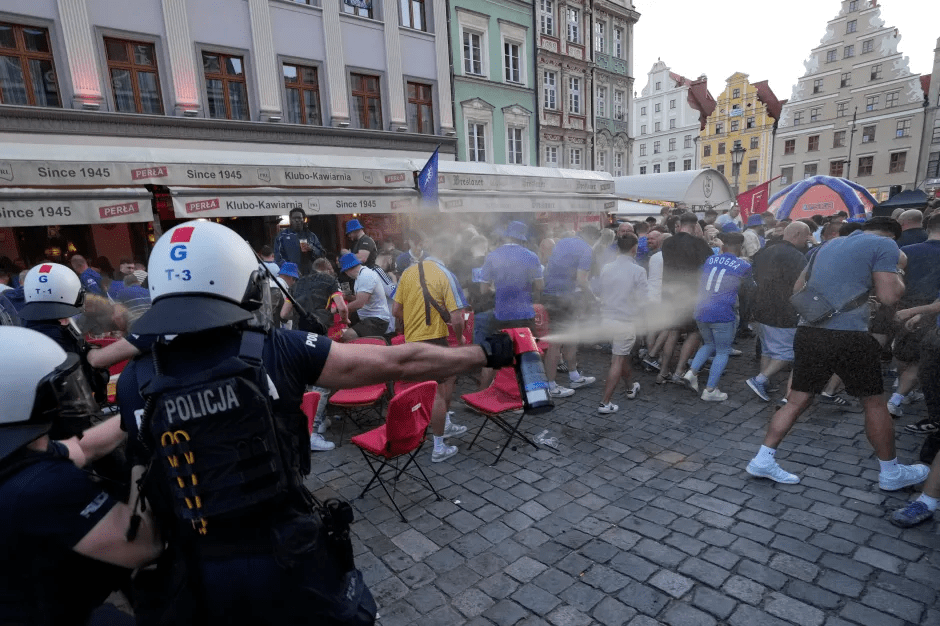 Police using pepper spray on a crowd of people.
