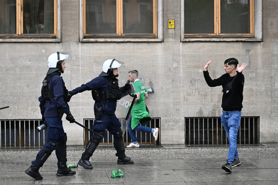 Police officers arresting a man.