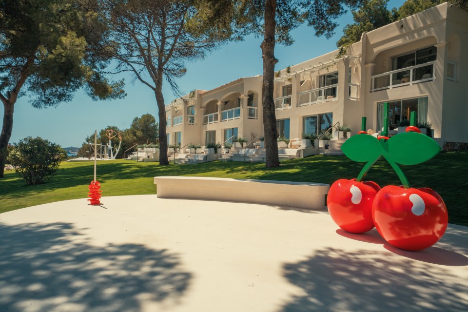 Pacha Ibiza luxury resort with large cherry sculptures.