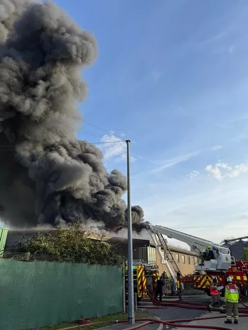 Large fire with firefighters responding.