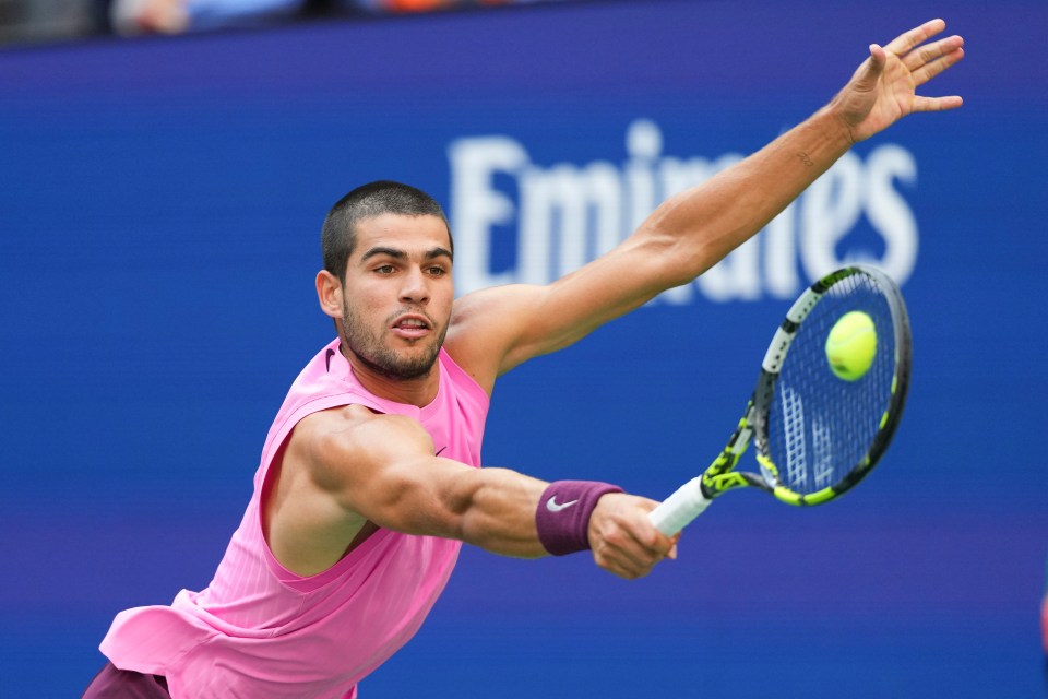 Carlos Alcaraz of Spain returning a tennis shot.