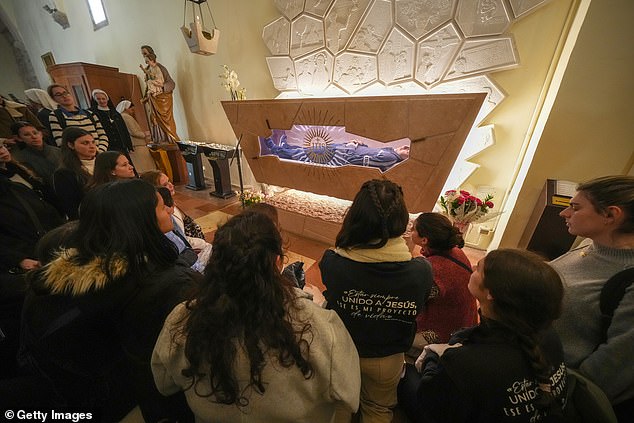 Pilgrims pray and pay their respects at the tomb of Blessed Carlo Acutis in March