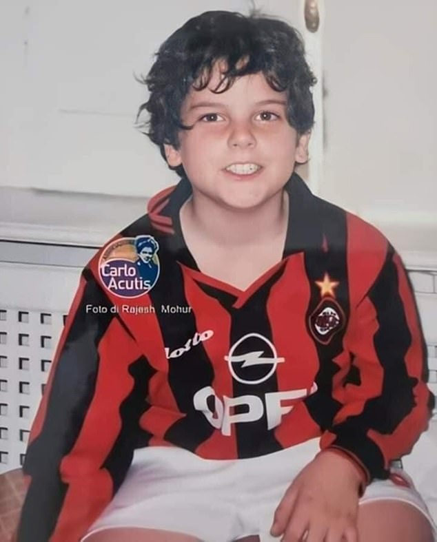 Carlo Acutis pictured smiling at the camera while sporting an AC Milan home kit from the 1990s