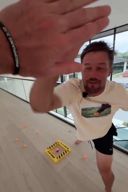 Man playing ping pong game indoors.
