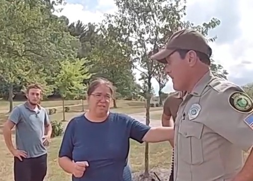 Amish woman being questioned by a park ranger.