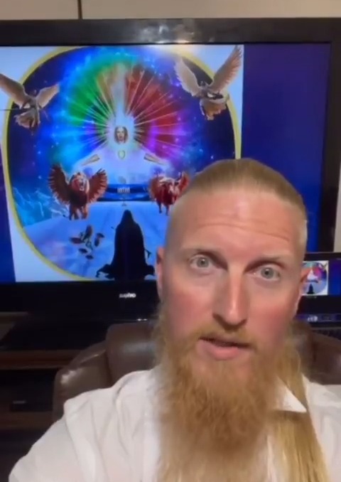 Man claiming to be "Michael the Angel of Death" in front of a screen displaying religious imagery.