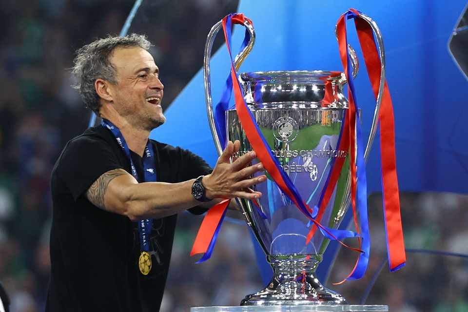 Luis Enrique holding the Champions League trophy.