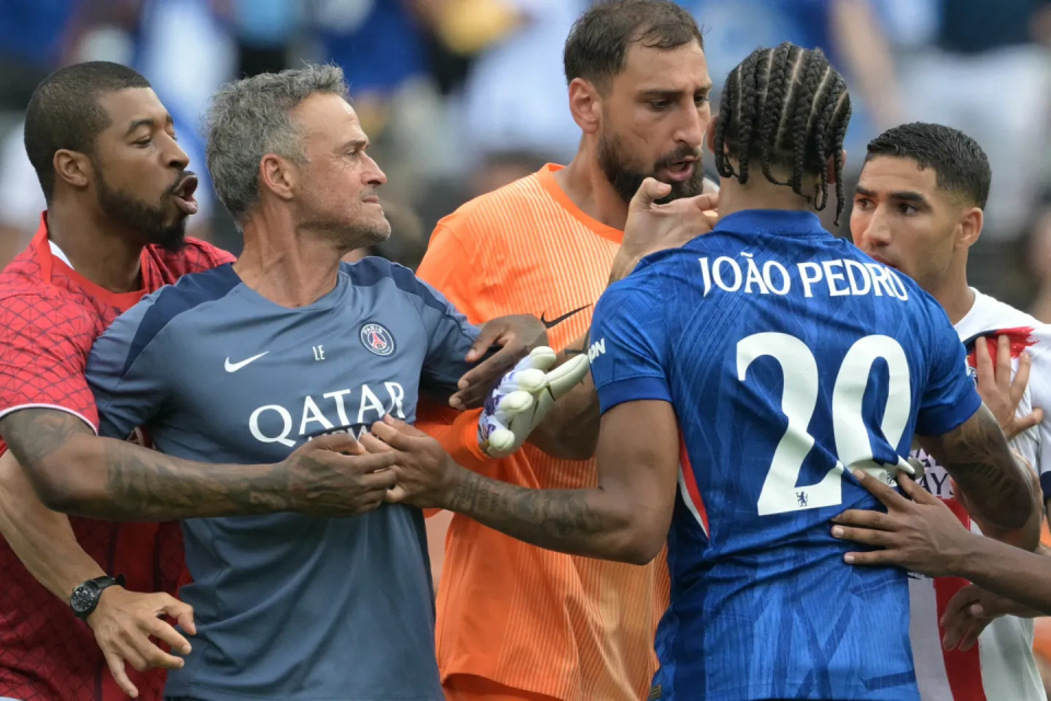 Soccer players and coaches arguing on the field.