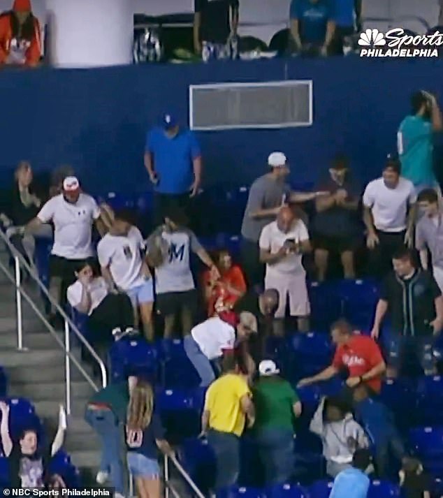 A dad (red shirt) raced over and beat out all the other fans to a loose ball on the ground