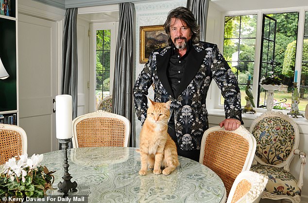 Laurence's living room doesn't end with 10 people under his roof, there's also room for four cats and three dogs in the manor