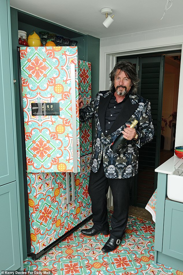 Laurence recently invested in a refrigerator that matches his bold kitchen floor