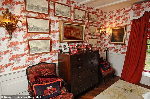 Artwork and lavish furnishings are all around the lavish bedroom, which overlooks the garden