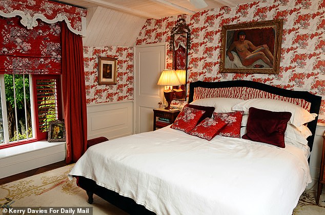 The bedroom is a vibrant scarlet space boasting clashing colours and patterns