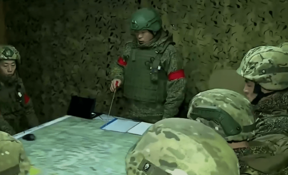 North Korean soldiers reviewing a map.