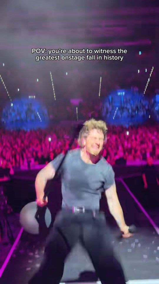 Tom Grennan falling on stage during a concert.