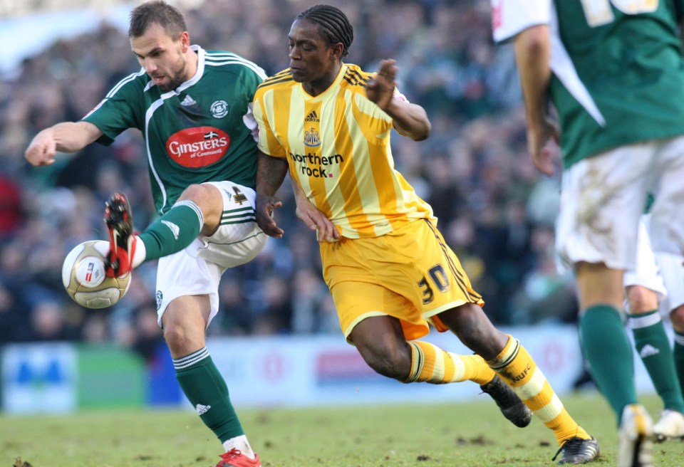 Nile Ranger challenging Carl Fletcher during a soccer match.