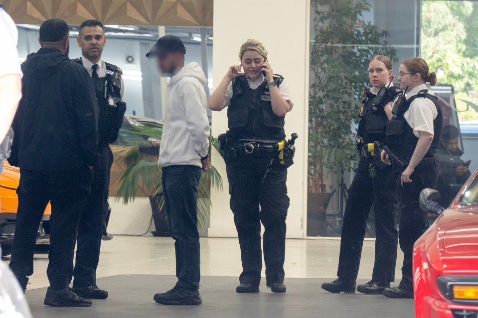 Police officers at a car dealership.