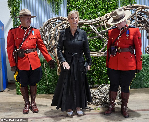 The Duchess of Edinburgh, shares a joke with Royal Canadian Mounted Police officers during her visit to Spruce Meadows