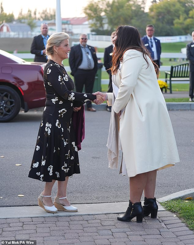 In the evening, she changed into florals for the Six Bar Challenge show jumping event, also at Spruce Meadows, of which she is patron