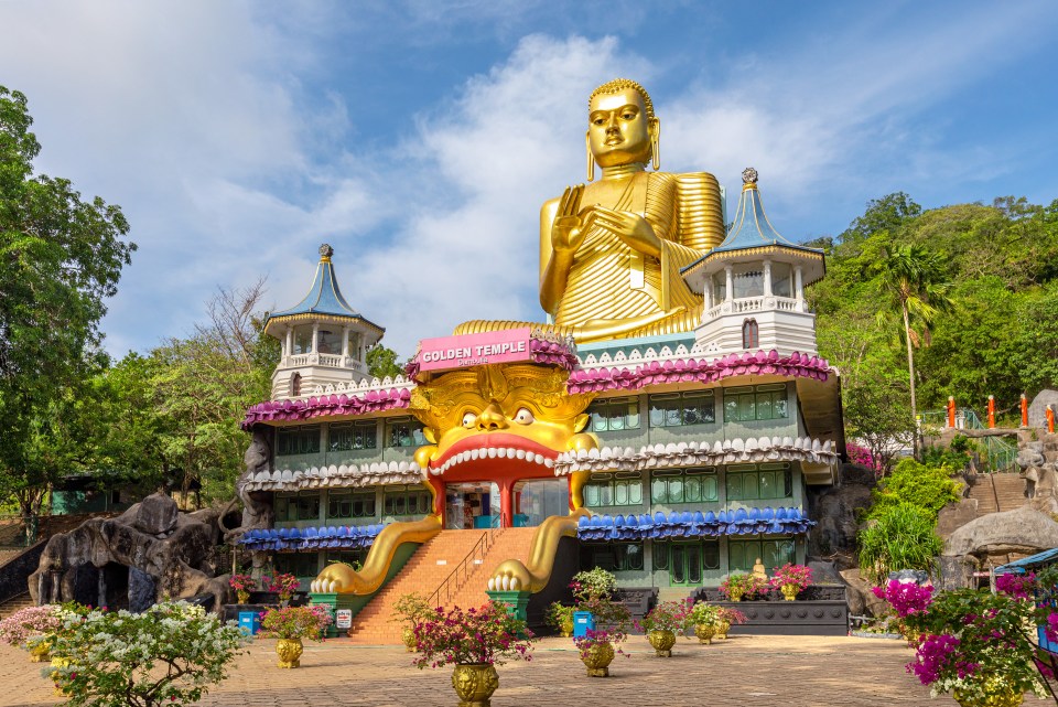 Large golden Buddha statue at the Dambulla Golden Temple in Sri Lanka.